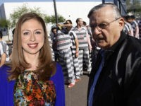PHOENIX, AZ - APRIL 17: Inmates walk as they are moved after being ordered by Maricopa County Sheriff Officer Joe Arpaio (R), looking on, to be placed into new housing to open up new beds for maximum security inmates on April 17, 2009 in Phoenix, Arizona. Arpaio has been facing criticism from Hispanic activists and lawmakers, alleging that Arpaio's crackdown methods on illegal immigrants involve racial profiling. (Photo by Joshua Lott/Getty Images)