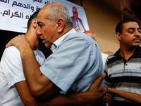 Hamdan Timraz, assistant regional director of the United Nations Department for Safety and Security in the Gaza Strip, embraces his son after his release upon arrival in Gaza City on August 8, 2017, after he was held in detention by Israel upon crossing the Beit Hanun crossing in early July. / AFP PHOTO / MOHAMMED ABED (Photo credit should read MOHAMMED ABED/AFP/Getty Images)