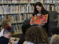 In this Wednesday, July 12, 2017 photo, Sandra Collins, executive director and founder of enGender, reads a book to campers at the Bay Area Rainbow Day Camp in El Cerrito, Calif. Collins says, “A lot of these kids have been bullied and had trauma at school. This is a world where none of that exists, and they're in the majority. That’s a new experience for kids who are used to hiding and feeling small.” (AP Photo/Jeff Chiu)