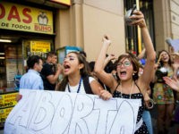 Activists take part in a demo in favor of abortion in Santiago on March 21, 2016. Lawmakers in Chile's lower house of Congress on Thursday approved abortion in limited circumstances, the first step towards lifting a decades-old ban on the practice in the socially conservative South American country. Chile is one of the few countries in the world that does not allow abortion under any circumstances at all. AFP PHOTO / MARTIN BERNETTI / AFP / MARTIN BERNETTI (Photo credit should read MARTIN BERNETTI/AFP/Getty Images)