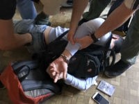 In this undated video grab provided by the RU-RTR Russian television via APTN on Monday, Aug. 14, 2017, Russian FSB officers arrest a man on suspicion of plotting a series of attacks outside Moscow, Russia. Russia's main intelligence agency said on Monday it has foiled a plot led by two Soviet-born militants fighting for the Islamic State group in Syria. The FSB did not say when the arrests took place. (RU-RTR Russian Television/ APTN via AP)