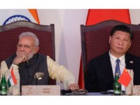 Indian Prime Minister Narendra Modi, left, and Chinese President Xi Jinping listen to a speech during the BRICS Leaders Meeting with the BRICS Business Council in Goa, India, Sunday, Oct. 16, 2016. Brazil, Russia, India, China and South Africa, or BRICS, face the tough task of asserting their growing influence as a power group even as they bridge their own trade rivalries to help grow their economies. (AP Photo/Manish Swarup)