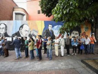 Voters wait in line to cast their ballots at the Andres Bello High School polling center during the elections for a constituent assembly in downtown Caracas, Venezuela, on Sunday, July 30, 2017. This vote, which was convened by President Nicolas Maduro, is the first step in a potential overhaul of the country's constitution which threatens to upend six decades of democracy in the oil-producing nation. Photographer: Carlos Becerra/Bloomberg via Getty Images
