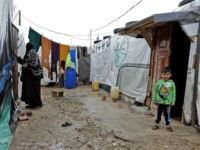 A Syrian refugee child stands at the entrance of his tent at an unofficial refugee camp in the village of Deir Zannoun in Lebanon's Bekaa valley in January 2017