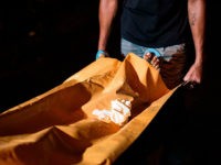 This photo taken on July 15, 2017 shows a coroner a stretcher with the body of an alleged drug dealer murdered by unidentified assaillants in Manila. European Union lawmakers on July 17 expressed concern over the killings in Philippine President Rodrigo Duterte's war on drugs and his possible extension of martial law. / AFP PHOTO / NOEL CELIS (Photo credit should read NOEL CELIS/AFP/Getty Images)