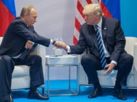 HAMBURG, GERMANY - JULY 07: Russian President Vladimir Putin (left) and President of the United States of America Donald Trump (right) shake hands during the meeting at G20 Summit on July 7, 2017 in Hamburg, Germany. (Photo by Dmitry Azarov/Kommersant via Getty Images)