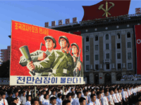North Koreans wave banners and shout slogans at a state organised anti-American rally in Pyongyang