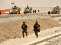 US soldiers walk at the site of a Taliban suicide attack in Kandahar on August 2, 2017. A Taliban suicide bomber on August 2 rammed a vehicle filled with explosives into a convoy of foreign forces in Afghanistan's restive southern province of Kandahar, causing casualties, officials said. 'At around noon a car bomb targeted a convoy of foreign forces in the Daman area of Kandahar,' provincial police spokesman Zia Durrani told AFP. / AFP PHOTO / JAVED TANVEER (Photo credit should read JAVED TANVEER/AFP/Getty Images)