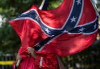 New York stocks rose despite developments in Washington, with the Dow rising above 22,000 even as Trump disbanded a pair of business advisory boards after several chief executives resigned over his response to a white supremacist rally in Charlottesville.