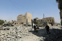 Fighters from the Syrian Democratic Forces, a US-backed Kurdish-Arab alliance, battle to retake the devastated city of Raqa in northern Syria from the Islamic State group