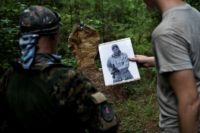 Members of the Georgia Security Force militia puts targets up before the group participates in live fire training in Jackson, Georgia