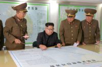 North Korean leader Kim Jong-Un (C) ast week delayed the Guam strike plan, but warned it could go ahead depending on Washington's next move