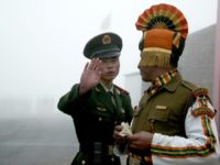 Photo taken on July 10, 2008 shows a Chinese soldier (L) gesturing next to an Indian soldier at the Nathu La border crossing between India and China in India's northeastern Sikkim state