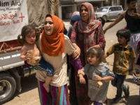 raqi women, who fled the fighting between government forces and Islamic State (IS) group jihadists in the Old City of Mosul, arrive in the city's western industrial district to be relocated, on July 8, 2017. / AFP PHOTO / Fadel SENNA (Photo credit should read FADEL SENNA/AFP/Getty Images)