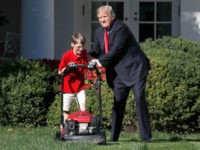 Frank Giaccio, 11, of Falls Church, Va., left, is encouraged by President Donald Trump, Friday, Sept. 15, 2017, while he mowed the lawn in the Rose Garden at the White House in Washington. The 11-year-old, who wrote the president requesting to mow the lawn at the White House, was so focused on the job at hand the he didn't notice the president until he was right next to him. (AP Photo/Jacquelyn Martin)