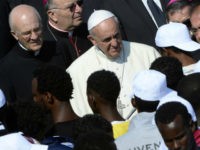 Pope Francis (C) speaks to migrants during his visit to the island of Lampedusa, a key destination of tens of thousands of would-be immigrants from Africa, on July 8, 2013. Pope Francis called for an end to 'indifference' to the plight of refugees on Monday on a visit to an Italian island where tens of thousands of migrants from Africa and the Middle East first reach Europe. AFP PHOTO / ANDREAS SOLARO (Photo credit should read ANDREAS SOLARO/AFP/Getty Images)