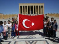 In this March 29, 2017 file photo, schoolchildren visiting the mausoleum of Mustafa Kemal Ataturk, the founder of modern Turkey, poses for pictures with their teachers in Ankara, Turkey. (Lefteris Pitarakis / AP)