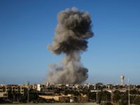 TOPSHOT - Smoke rise after an airstrike on the District 3 of Sirte, the last stronghold of Islamic State (IS) on September 28, 2016. France will host an international meeting on strife-ridden Libya next week featuring several countries in the region including Egypt and Gulf states, the French government's spokesman said. / AFP / Fabio Bucciarelli (Photo credit should read FABIO BUCCIARELLI/AFP/Getty Images)