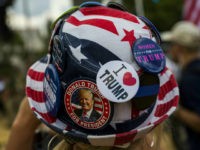 A demonstrator wears a hat with the colours of the US flag and pro-Trump slogans the 'Mother of All Rallies' in support of the US president held on the National Mall in Washington, DC on September 16, 2017. Supporters of President Donald Trump gathered in the US capital to show support of 'free-speech' dubbed the Mother of All Rallies. / AFP PHOTO / ZACH GIBSON (Photo credit should read ZACH GIBSON/AFP/Getty Images)