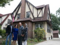 In this Saturday, Sept. 16, 2017 photo, Abdi Iftin, left, of Somalia, Uyen Nguyen, second from left, of Vietnam, Eiman Ali, right, of Somalia born in Yemen, and Ghassan al-Chahada, of Syria pose for a photo outside President Donald Trump's boyhood home in the Jamaica Estates neighborhood of the Queens borough of New York. The house that Trump’s father built is now a rental available on Airbnb. The international anti-poverty organization Oxfam rented it Saturday and invited refugees to share their stories with journalists. (AP Photo/Mary Altaffer)