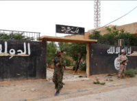 A picture taken during a press tour provided by the Russian Armed Forces on September 15, 2017 shows Syrian soldiers standing outside a building which was used by Islamic State (IS) group members as an Islamic court, in the town of Uqayribat in Syria's eastern Hama countryside. / AFP PHOTO / Maria ANTONOVA (Photo credit should read MARIA ANTONOVA/AFP/Getty Images)