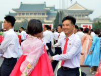 North Koreans dance in Pyongyang celebrating the 69th anniversary of North Korea's national day, on September 9, 2017