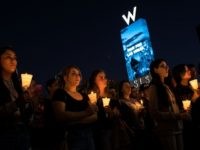 LAS VEGAS, NV - OCTOBER 2: Mourners attend a candlelight vigil at the corner of Sahara Avenue and Las Vegas Boulevard for the victims of Sunday night's mass shooting, October 2, 2017 in Las Vegas, Nevada. Late Sunday night, a lone gunman killed more than 50 people and injured more than 500 people after he opened fire on a large crowd at the Route 91 Harvest Festival, a three-day country music festival. The massacre is one of the deadliest mass shooting events in U.S. history. (Photo by Drew Angerer/Getty Images)