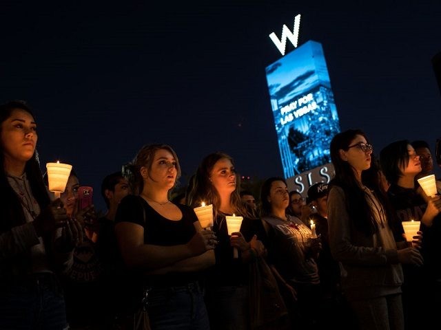 LAS VEGAS, NV - OCTOBER 2: Mourners attend a candlelight vigil at the corner of Sahara Avenue and Las Vegas Boulevard for the victims of Sunday night's mass shooting, October 2, 2017 in Las Vegas, Nevada. Late Sunday night, a lone gunman killed more than 50 people and injured more than 500 people after he opened fire on a large crowd at the Route 91 Harvest Festival, a three-day country music festival. The massacre is one of the deadliest mass shooting events in U.S. history. (Photo by Drew Angerer/Getty Images)