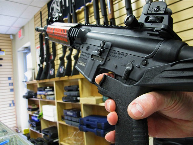 FILE - In this Feb. 1, 2013, file photo, an employee of North Raleigh Guns demonstrates how a "bump" stock works at the Raleigh, N.C., shop. The gunman who unleashed hundreds of rounds of gunfire on a crowd of concertgoers in Las Vegas on Monday, Oct. 2, 2017, attached what is called a "bump-stock" to two of his weapons, in effect converting semiautomatic firearms into fully automatic ones. (AP Photo/Allen Breed, File)