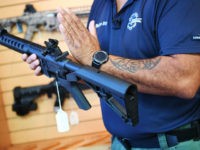 Senior Sales Staff Mark Warner shows a bump stock installed on an AR-15 rifle at Blue Ridge Arsenal in Chantilly, Virgina, on October 6, 2017. / AFP PHOTO / JIM WATSON (Photo credit should read JIM WATSON/AFP/Getty Images)