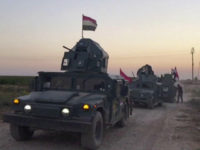 This image made from a video shows Iraqi soldiers on military vehicles in the Qatash area towards Kirkuk gas plant, south of Kirkuk, Iraq, Monday, Oct. 16, 2017. Iraqi state media say federal troops have entered disputed territories occupied by the nation's Kurds. The move comes three years after Kurdish militias seized the areas outside their autonomous region to defend against an advance by the Islamic State extremist group. (APTN via AP)