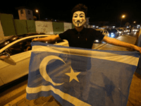 An Iraqi waves the Turkmen flag in Kirkuk to celebrate after Iraqi government forces retook the ethnically mixed city from Kurdish peshmerga fighters