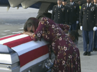 ADDS TRUMP'S RESPONSE TO REP. WILSON - In this Tuesday, Oct. 17, 2017, frame from video, Myeshia Johnson cries over the casket of her husband, Sgt. La David Johnson, who was killed in an ambush in Niger, upon his body's arrival in Miami. President Donald Trump told the widow that her husband "knew what he signed up for," according to Rep. Frederica Wilson, who said she heard part of the conversation on speakerphone. In a Wednesday morning tweet, Trump said Wilson's description of the call was "fabricated." (WPLG via AP)