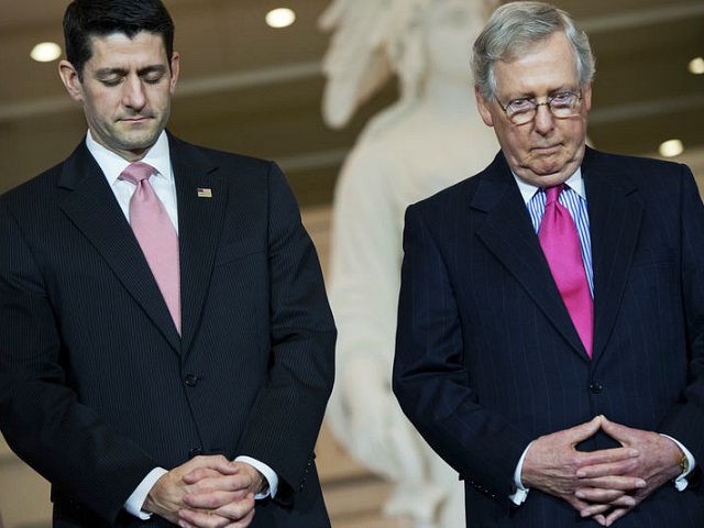 UNITED STATES - FEBRUARY 24: Speaker Paul D. Ryan, R-Wisc., left, and Senate Majority Leader Mitch McConnell, R-Ky., bow their heads in prayer during a Congressional Gold Medal ceremony in the Capitol Visitor Center's Emancipation Hall for the 'Foot Soldiers of the 1965 Voting Rights Marches, a group of men and women who peacefully marched from Selma to Montgomery in protest of the denial of their right to vote,' February 24, 2016. (Photo By Tom Williams/CQ Roll Call)