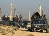Iraqi forces pass an oil production plant as they advance towards the city of Kirkuk on October 16, 2017 in their campaign to retake the disputed province from the Kurds