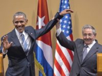 FILE - In this March 21, 2016 file photo, Cuban President Raul Castro, right, lifts up the arm of U.S. President Barack Obama, at the conclusion of their joint news conference at the Palace of the Revolution, in Havana, Cuba. The United States will vote this week against an annual United Nations resolution condemning the U.S. embargo on Cuba, reversing the Obama administration’s abstention last year. (AP Photo/Ramon Espinosa, File)