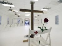 A memorial for the victims of the shooting at Sutherland Springs First Baptist Church includes 26 white chairs, each painted with a cross and and rose, is displayed in the church Sunday, Nov. 12, 2017, in Sutherland Springs, Texas. A man opened fire inside the church in the small South Texas community last week, killing more than two dozen. (AP Photo/Eric Gay)