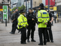 Armed police stand guard near the start of the Great Manchester Run in Manchester on May 28, 2017. Britain police have released CCTV footage of Manchester bomber Salman Abedi on the night of the attack as thousands defied the terror threat to take part in the Great Manchester Run on Sunday. / AFP PHOTO / JON SUPER (Photo credit should read JON SUPER/AFP/Getty Images)