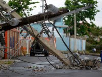 Power line poles downed by the passing of Hurricane Maria lie on a street in San Juan, Puerto Rico on November 7, 2017. The Center for Puerto Rican Studies at Hunter College in New York estimated in a report released last month that about 114,000 to 213,000 Puerto Rican residents will leave the island annually 'as a result of Hurricane Maria.' / AFP PHOTO / Ricardo ARDUENGO (Photo credit should read RICARDO ARDUENGO/AFP/Getty Images)