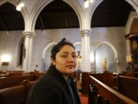 In this Oct. 26, 2017 photo, Amanda Morales, 33, poses for a photograph in the sanctuary of the Holyrood Episcopal Church, northern Manhattan. Morales has been living in two small rooms of the gothic church at the northern edge of Manhattan since August, shortly after immigration authorities ordered her deported to her homeland of Guatemala. (AP Photo/Kathy Willens)