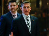 FILE - In this Nov. 17, 2016 file photo, Retired Lt. Gen Michael Flynn talks to media as he arrives with is son Michael G. Flynn, left, at Trump Tower in New York. Michael G. Flynn tweeted about the false idea that prompted a shooting at a Washington, D.C., pizza parlor. Vice President-elect Mike Pence acknowledged Tuesday, Dec. 6, that the younger Flynn was helping his father with scheduling and administrative items during the presidential transition but told CNN "that's no longer the case." (AP Photo/Carolyn Kaster, File)