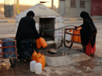 A Thursday Oct. 19, 2017 file photo of Moroccan women filling up containers with water from a hose, in Zagora, southeastern Morocco. Experts blame poor choices in agriculture, growing populations and climate change for the water shortages in towns like Zagora, which has seen repeated protests for access to clean water in recent weeks. Moroccan state TV channel 2M reports that at least 15 people have died and 5 others have been injured in a stampede Sunday Nov. 19, 2017 as food aid was being distributed in the village of Sidi Boulalam, in the southern province of Essaouira. (AP Photo/Issam Oukhouya, File)