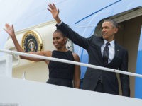 US President Barack Obama and First Lady Michelle Obama wave from Air Force One prior to departing from Andrews Air Force Base in Maryland, August 7, 2015. The Obamas are traveling to Martha's Vineyard, Massachusetts, for a 2-week vacation. AFP PHOTO / SAUL LOEB (Photo credit should read SAUL LOEB/AFP/Getty Images)