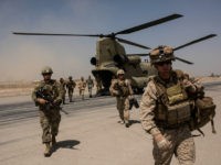 CAMP BOST, AFGHANISTAN - SEPTEMBER 11: U.S. service members walk off a helicopter on the runway at Camp Bost on September 11, 2017 in Helmand Province, Afghanistan. About 300 marines are currently deployed in Helmand Province in a train, advise, and assist role supporting local Afghan security forces. Currently the United States has about 11,000 troops in the deployed in Afghanistan, with a reported 4,000 more expected to arrive in the coming weeks. Last month, President Donald Trump announced his plan for Afghanistan which called for an increase in troop numbers and a new conditions-based approach to the war, getting rid of a timetable for the withdrawal of American forces in the country. (Photo by Andrew Renneisen/Getty Images)