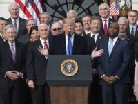 President Donald Trump joined by Senate Majority Leader Mitch McConnell of Ky., Vice President Mike Pence, Speaker of the House Paul Ryan, R-Wis., Sen. Tim Scott, R-S.C., front right, and other members of congress, speaks during an event on the South Lawn of the White House in Washington, Wednesday, Dec. 20, 2017, to acknowledge the final passage of tax overhaul legislation by Congress. (AP Photo/Carolyn Kaster)