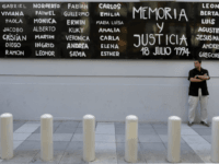 A man stands guard in front of the headquarters of AMIA (Argentine Israelite Mutual Association), in Buenos Aires on January 21, 2015, to protest against the death of Argentine public prosecutor Alberto Nisman, who was found shot dead earlier, just days after accusing President Cristina Kirchner of obstructing a probe into a 1994 Jewish center bombing. Nisman, 51, who was just hours away from testifying at a congressional hearing, was found dead overnight in his apartment in the trendy Puerto Madero neighbourhood of the capital. 'I can confirm that a 22-caliber handgun was found beside the body,' prosecutor Viviana Fein said. The nation's top security official said Nisman appears to have committed suicide. AFP PHOTO/ALEJANDRO PAGNI (Photo credit should read ALEJANDRO PAGNI/AFP/Getty Images)