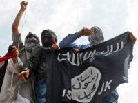 Kashmiri demonstrators hold up a flag of the Islamic State of Iraq and the Levant (ISIL) during a demonstration against Israeli military operations in Gaza, in downtown Srinagar on July 18, 2014. The death toll in Gaza hit 265 as Israel pressed a ground offensive on the 11th day of an assault aimed at stamping out rocket fire, medics said. AFP PHOTO/Tauseef MUSTAFA (Photo credit should read TAUSEEF MUSTAFA/AFP/Getty Images)
