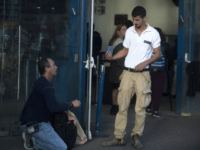 JERUSALEM, ISRAEL - DECEMBER 10: (ISRAEL OUT) Israeli security guard checks a man at the scene of an attack at the Jerusalem Central Bus Station on December 10, 2017 in Jerusalem, Israel. An Israeli security guard was stabbed in the entrance to the city's central bus station. The attacker has been apprehended. Israel Police have said that the attacker, aged 24 and a Palestinian resident of the West Bank (Photo by Lior Mizrahi/Getty Images)