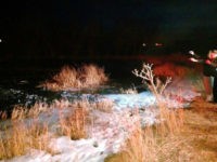 A sheriff's office photo shows the scene in New Harmony, Utah, on Monday night where a deputy dove into a frozen pond to pull out an 8-year-old who had fallen in.