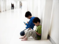 boys concentrating on video game
